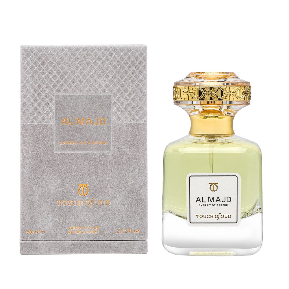 Touch of Oud Al Majd extrait perfume bottle with gold ornate cap and matching luxury box packaging