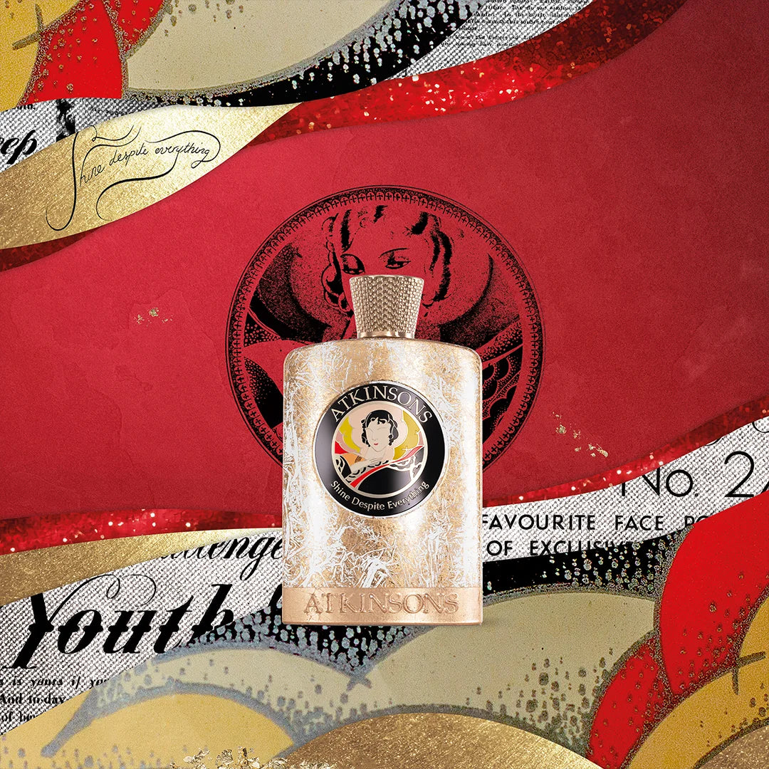 ATKINSONS Shine Despite Everything perfume bottle with floral accents on red background