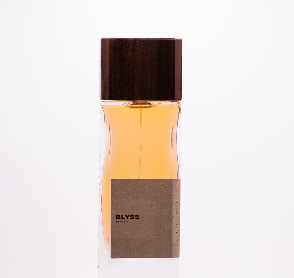 Perfumology Blyss 60ML perfume Dubai in a clear glass bottle with wooden cap and beige label