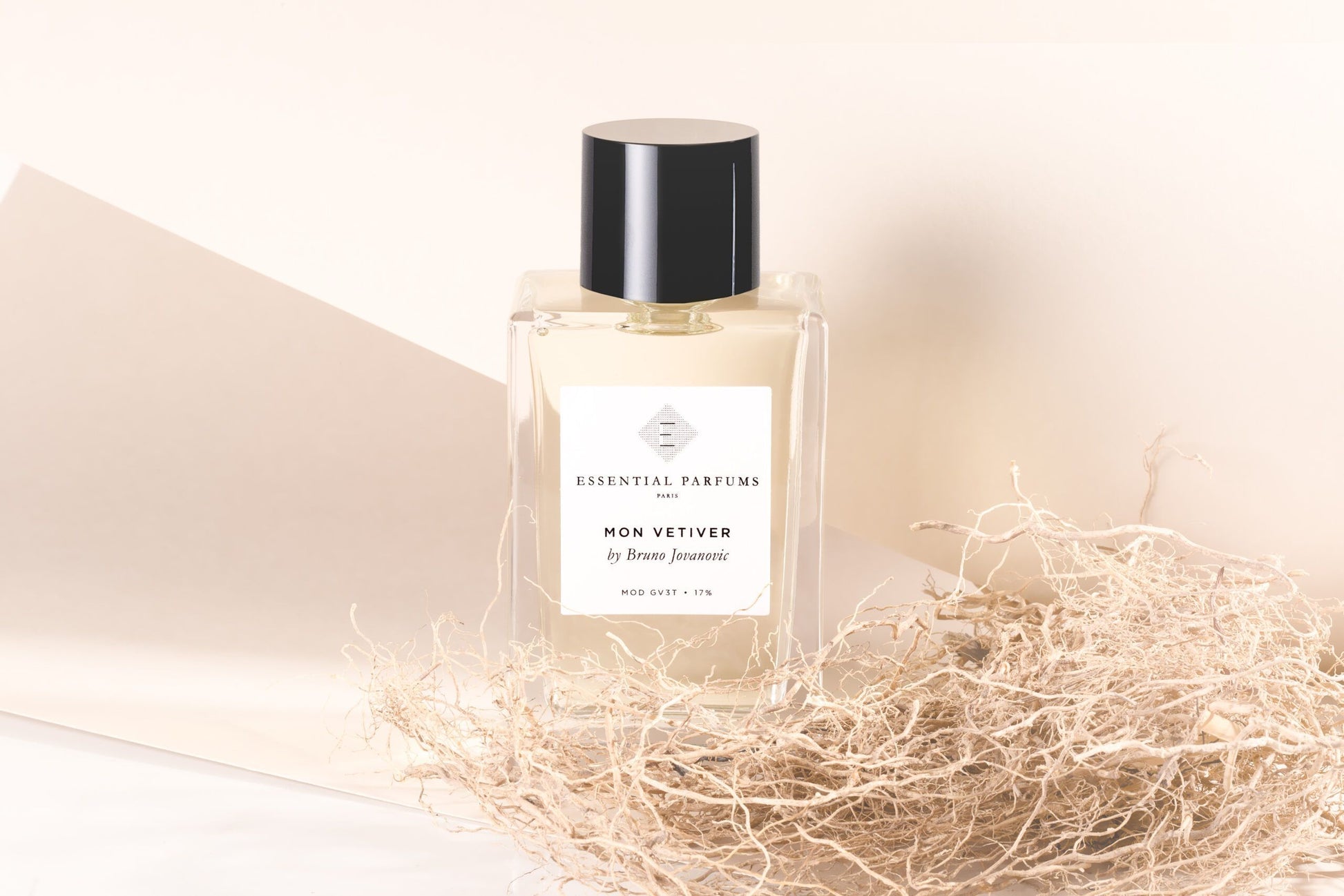 Essential Parfums Mon Vetiver 100ml perfume bottle with black cap surrounded by dried natural elements