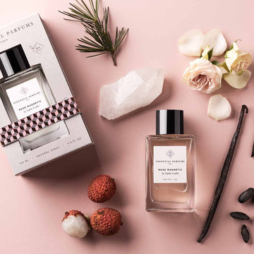 Essential Parfums Rose Magnetic perfume bottle and box with floral and natural elements on pink background