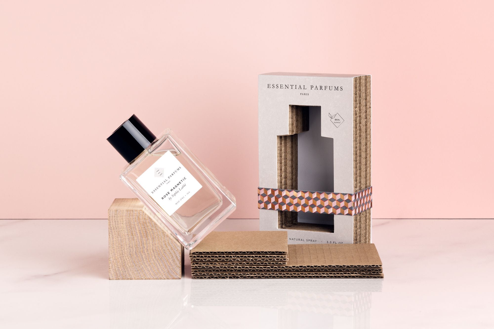 Essential Parfums Rose Magnetic perfume bottle with eco-friendly cardboard packaging on light pink background