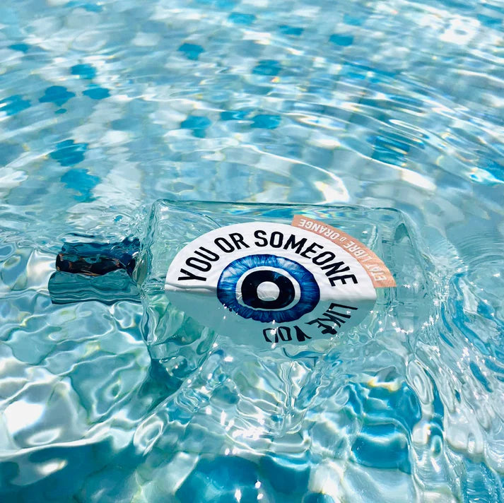 Etat Libre d'Orange You or Someone Like You perfume bottle floating in clear pool water