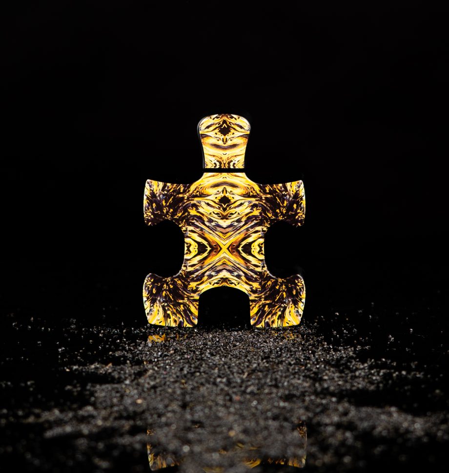 Puzzle Perfume bottle shaped like a puzzle piece with golden intricate patterns Fibonacci perfume Dubai