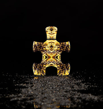 Puzzle Perfume bottle shaped like a puzzle piece with golden intricate patterns Fibonacci perfume Dubai