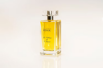 Finou La Noblesse Amour perfume in clear rectangular glass bottle with golden liquid and faceted cap