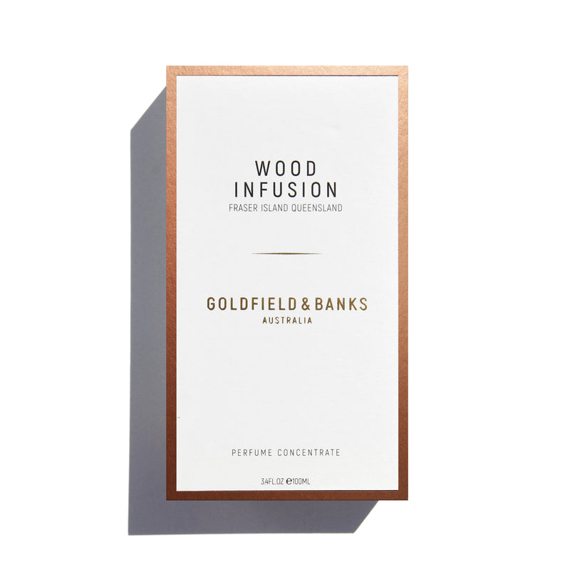 Goldfield and Banks wood infusion perfume in clear glass bottle with dark wooden cap and orange label