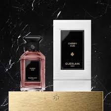 Guerlain Cherry Oud perfume in a stylish bottle with elegant packaging on a marble background