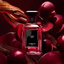 Guerlain Cherry Oud perfume in a stylish bottle surrounded by dark cherries and wood accents