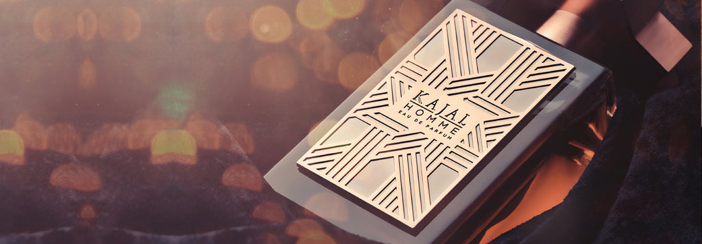 Kajal Homme perfume for men in a clear rectangular glass bottle with a copper geometric design and cap