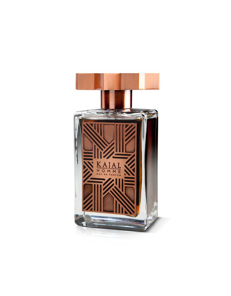 Kajal Homme perfume for men in a clear rectangular glass bottle with a copper geometric design and cap