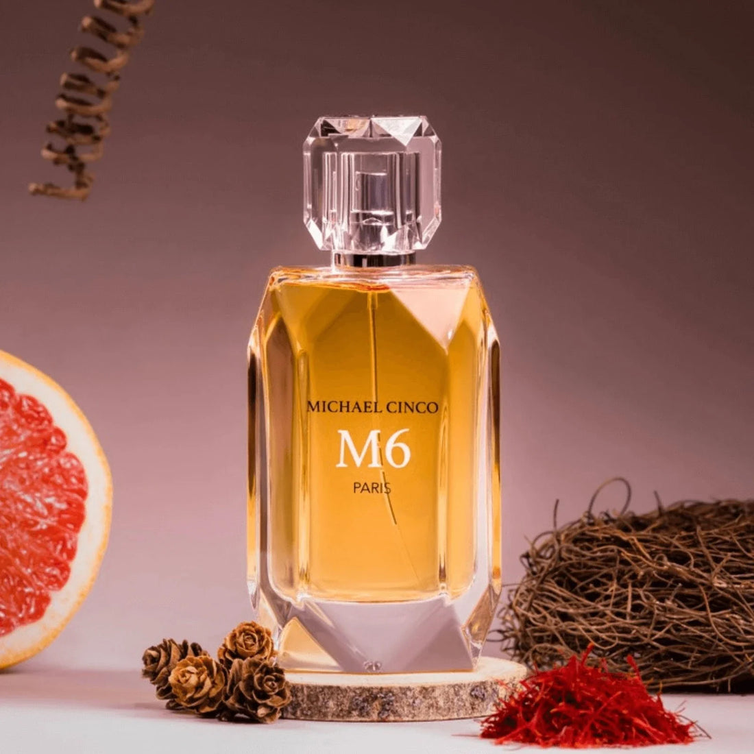 Michael Cinco M6 fragrance perfume bottle with warm amber color and decorative natural elements