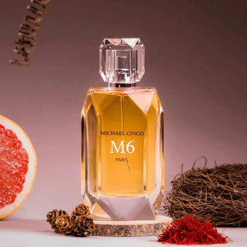 Michael Cinco M6 fragrance perfume bottle with warm amber color and decorative natural elements