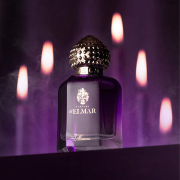 DELMAR MOMONA perfume Dubai bottle with ornate gold cap and purple glass against dark background