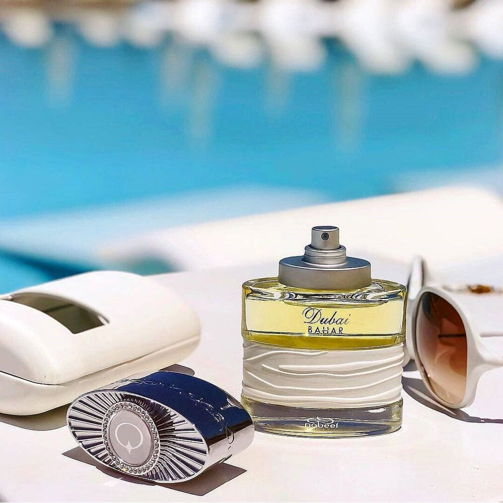 SPIRIT OF DUBAI Dubai Bahar perfume 50ml bottle with cap beside sunglasses on a white surface