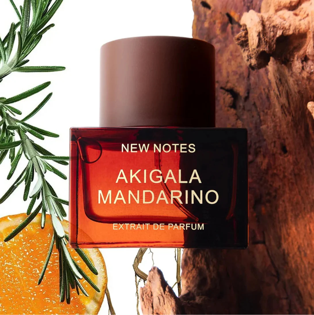NEW NOTES Akigala Mandarino extrait de parfum bottle with orange slice and rosemary on rustic background
