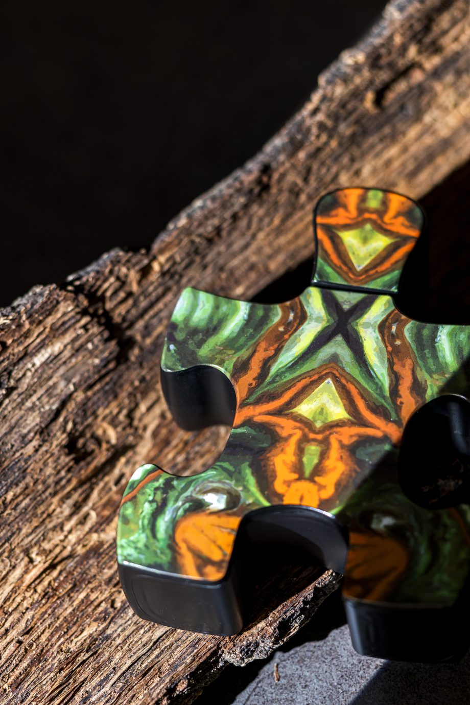 Colorful puzzle piece with vibrant orange green pattern representing Puzzle Purgatory perfume by Puzzle Perfume