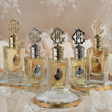 ROYAL GLORY LOVE WHISPERS perfume Dubai displayed in elegant glass bottles with ornate gold and silver caps