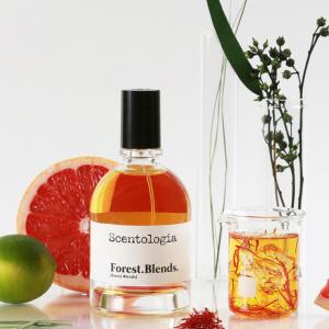 Scentologia perfume bottle labeled Forest. Blends. by Scentologia spraying on dark textured stone