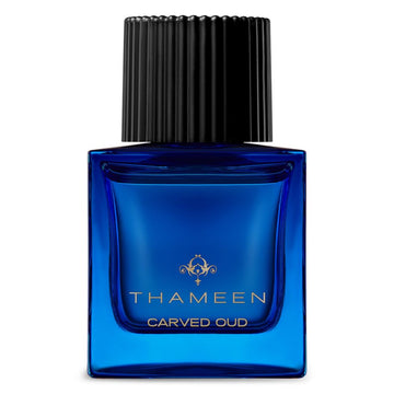 Thameen Carved Oud perfume in a blue glass bottle with black ribbed cap by Thameen London fragrance