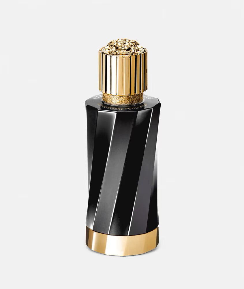 Versace Atelier Gingembre Petillant perfume bottle with ginger root and cinnamon sticks on white background