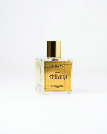 Emirati Moringa perfume by The Scent Library, a clear square glass bottle with a gold cap and gold grid label, The Collector's Edition