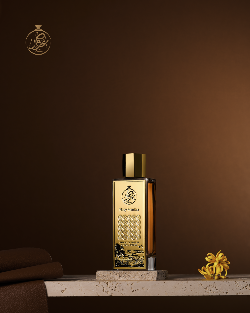 Aawed Perfumes Nosy Manitra EDP 100ml bottle with gold design on a stone surface against a brown background