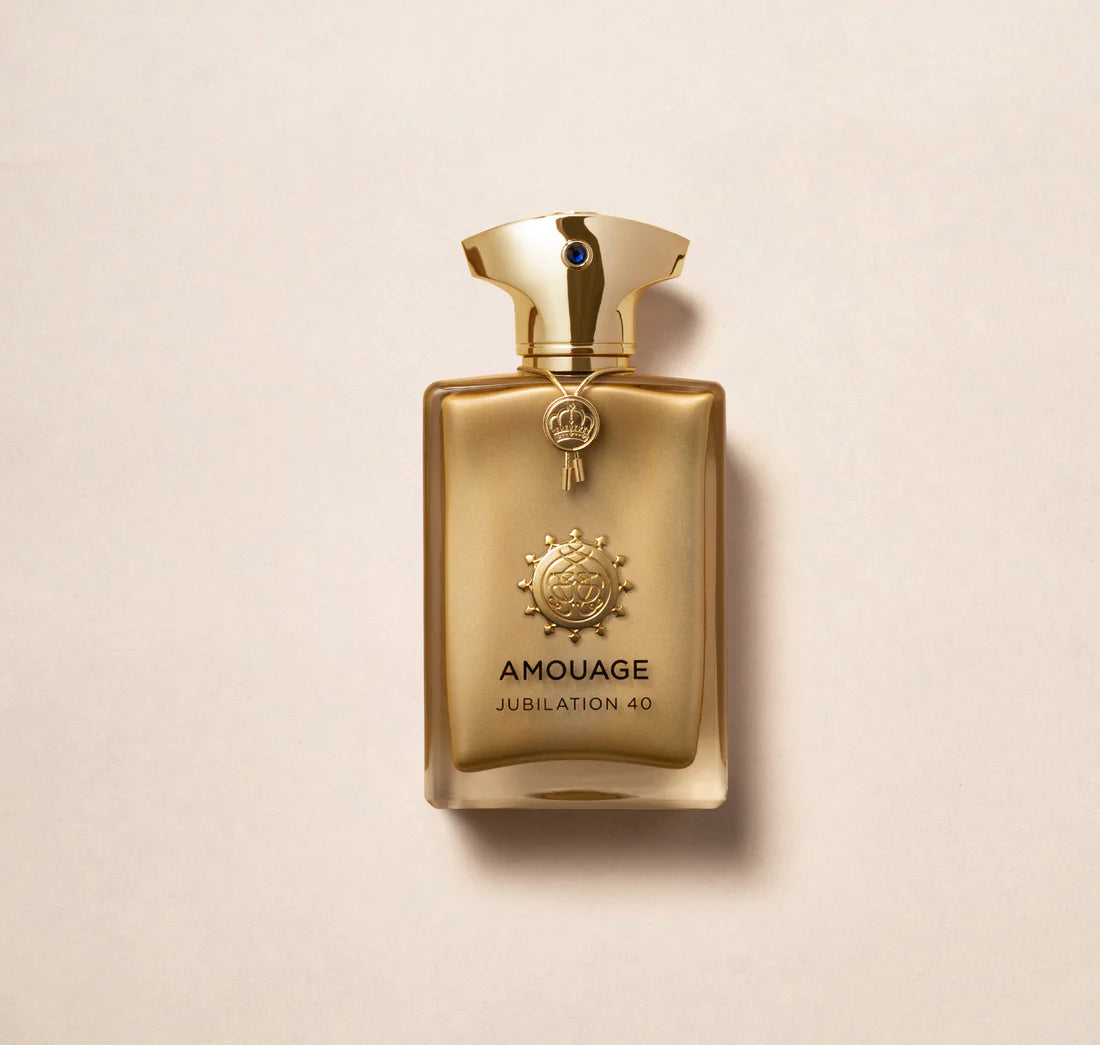 Amouage Jubilation 40 Extrait De Parfum gold bottle with ornate cap and emblem on beige background