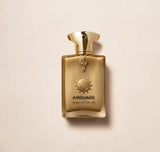 Amouage Jubilation 40 Extrait De Parfum gold bottle with ornate cap and emblem on beige background