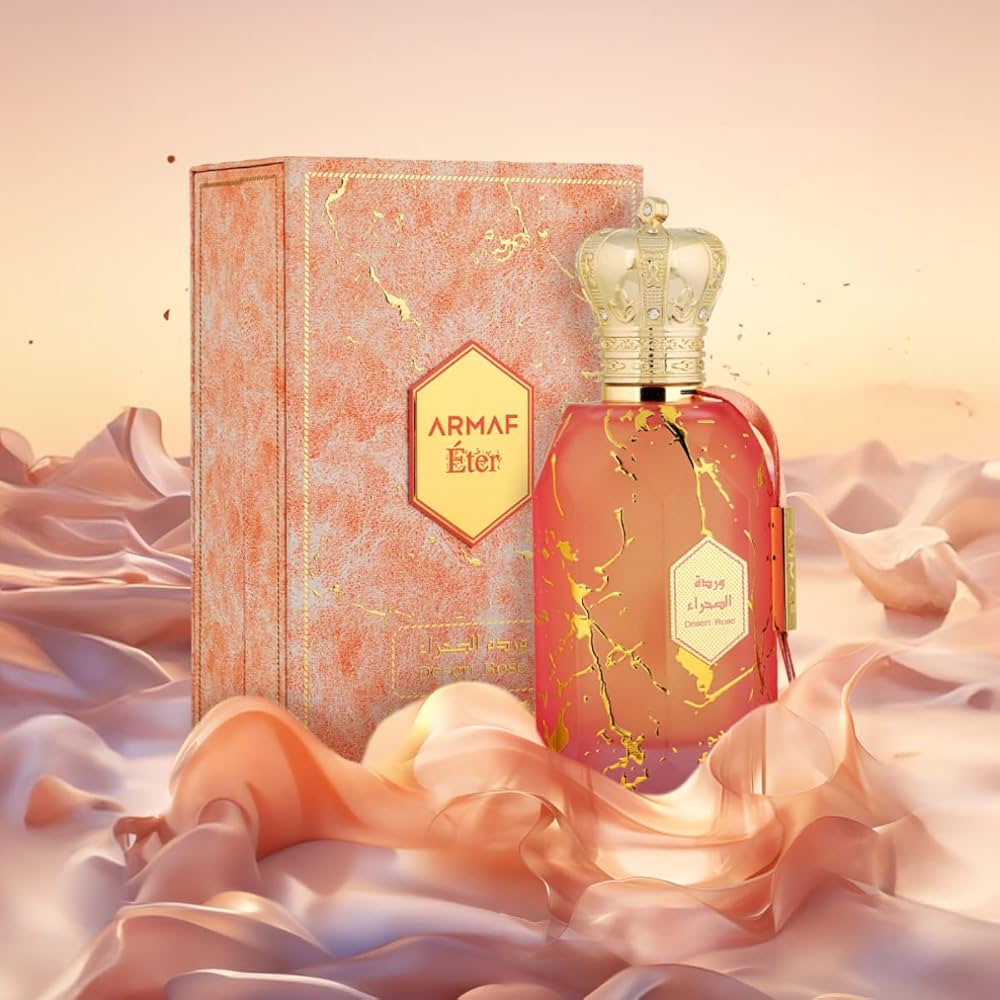 ARMAF Desert Rose perfume bottle with crown cap next to decorative box on silky fabric
