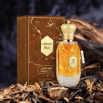 ARMAF ÉTER MAGICAL OUD perfume bottle with gold crown cap and matching brown box on natural wood background