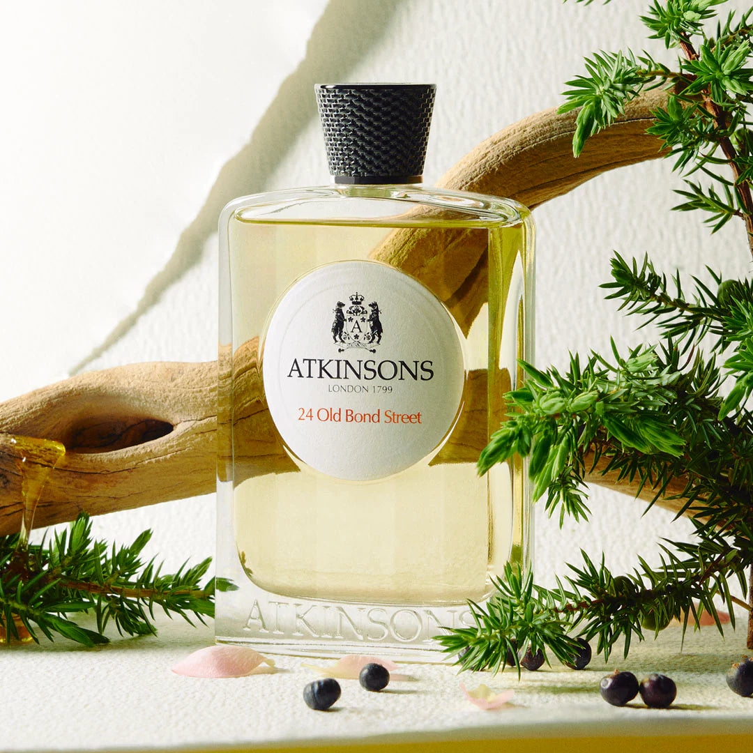 Atkinsons 24 Old Bond Street Eau de Cologne perfume bottle with natural wood and green leaves background