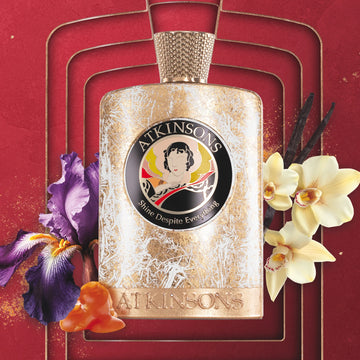 ATKINSONS Shine Despite Everything perfume bottle with floral accents on red background
