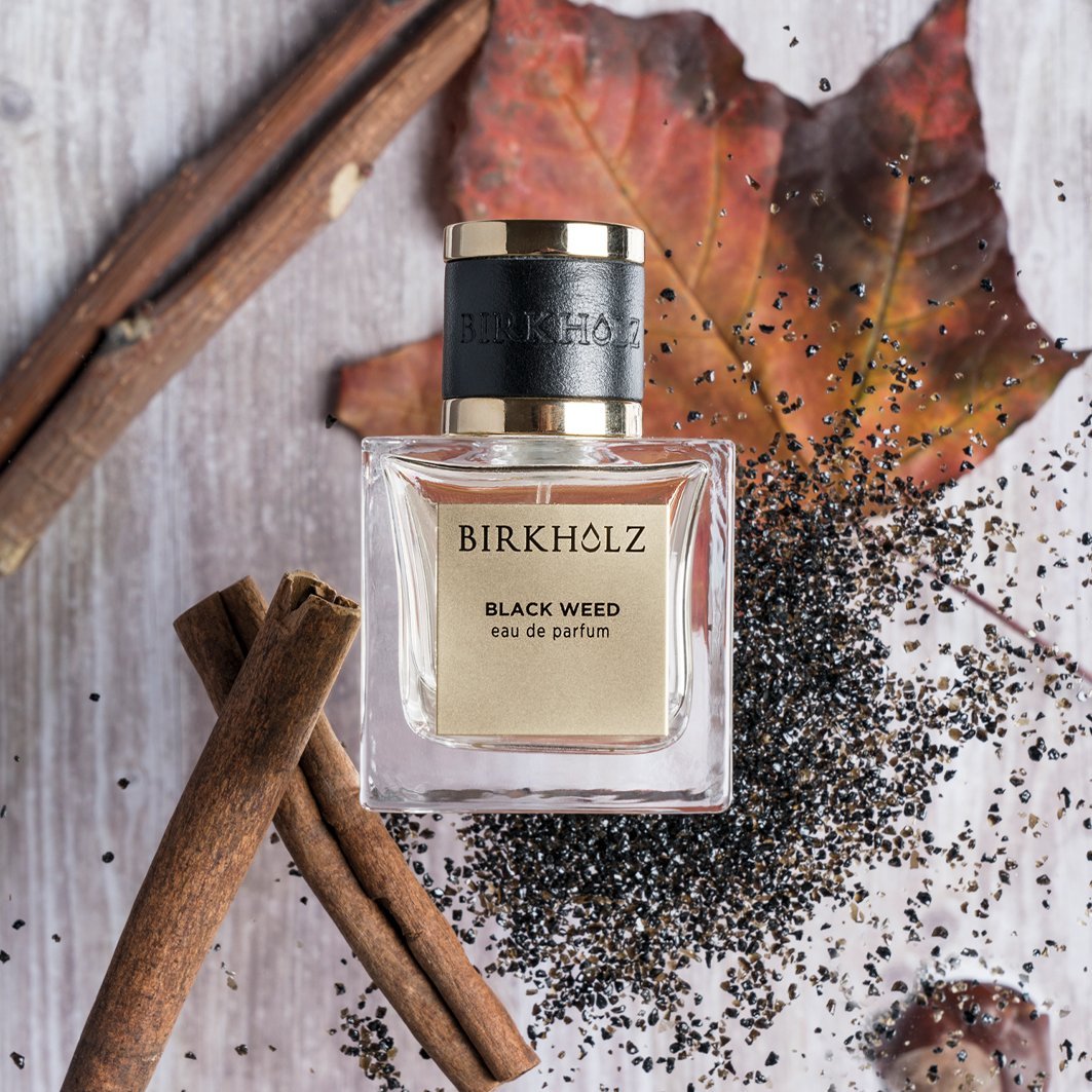 Birkholz Black Weed eau de parfum 100ml bottle with cinnamon sticks and autumn leaves background