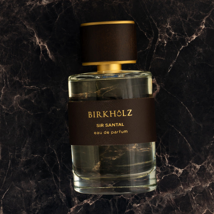 Birkholz Sir Santal eau de parfum bottle with brown leather label and gold cap on black marble background