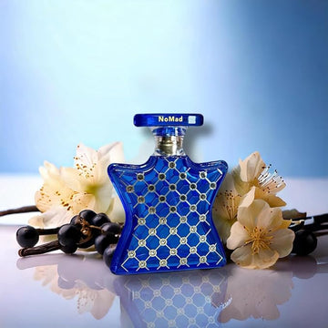 Bond No 9 Nomad perfume 100ml in a blue star-shaped bottle with floral and berry background