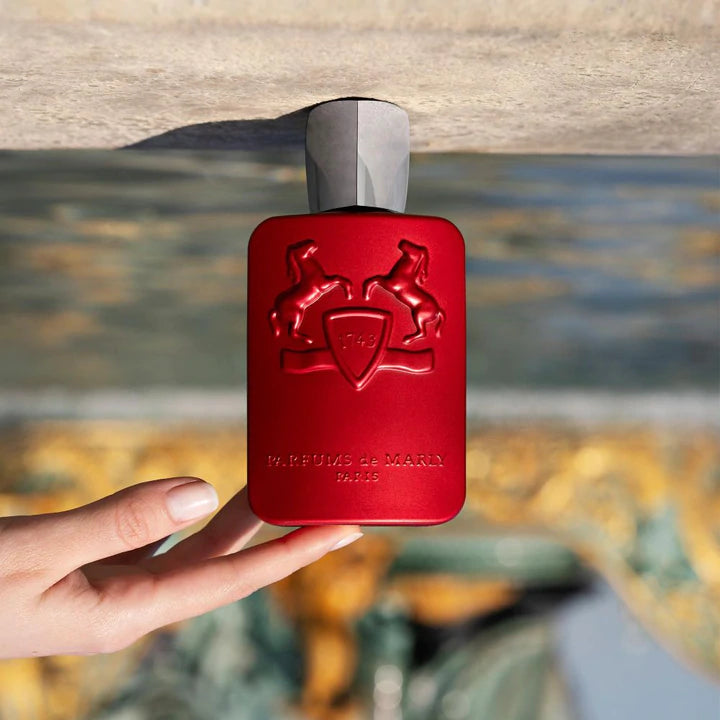 Hand holding red Parfums de Marly Kalan 125ml perfume bottle with embossed logo to buy Parfums de Marly Kalan 125ml