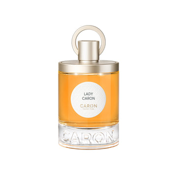 Caron Lady Caron Eau de Parfum bottle with amber liquid and gold cap on white background