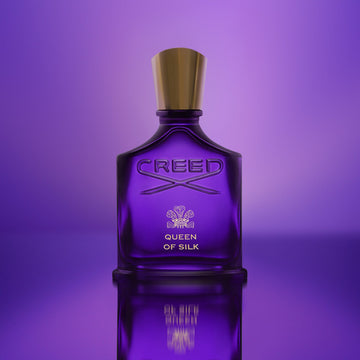 Creed Queen of Silk perfume 75ml in a purple glass bottle with gold cap on purple background