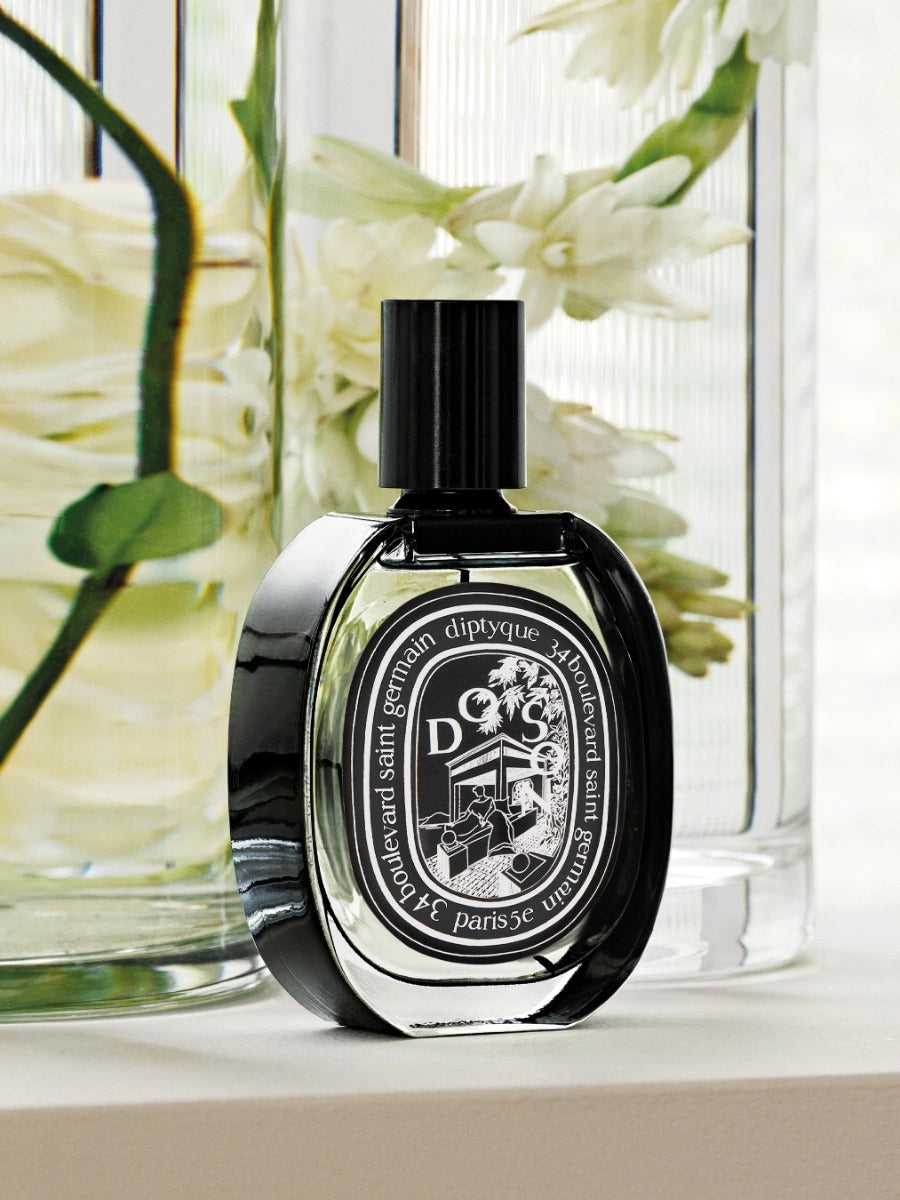 Diptyque Do Son Eau de Parfum 75ml in elegant black bottle beside fresh flowers
