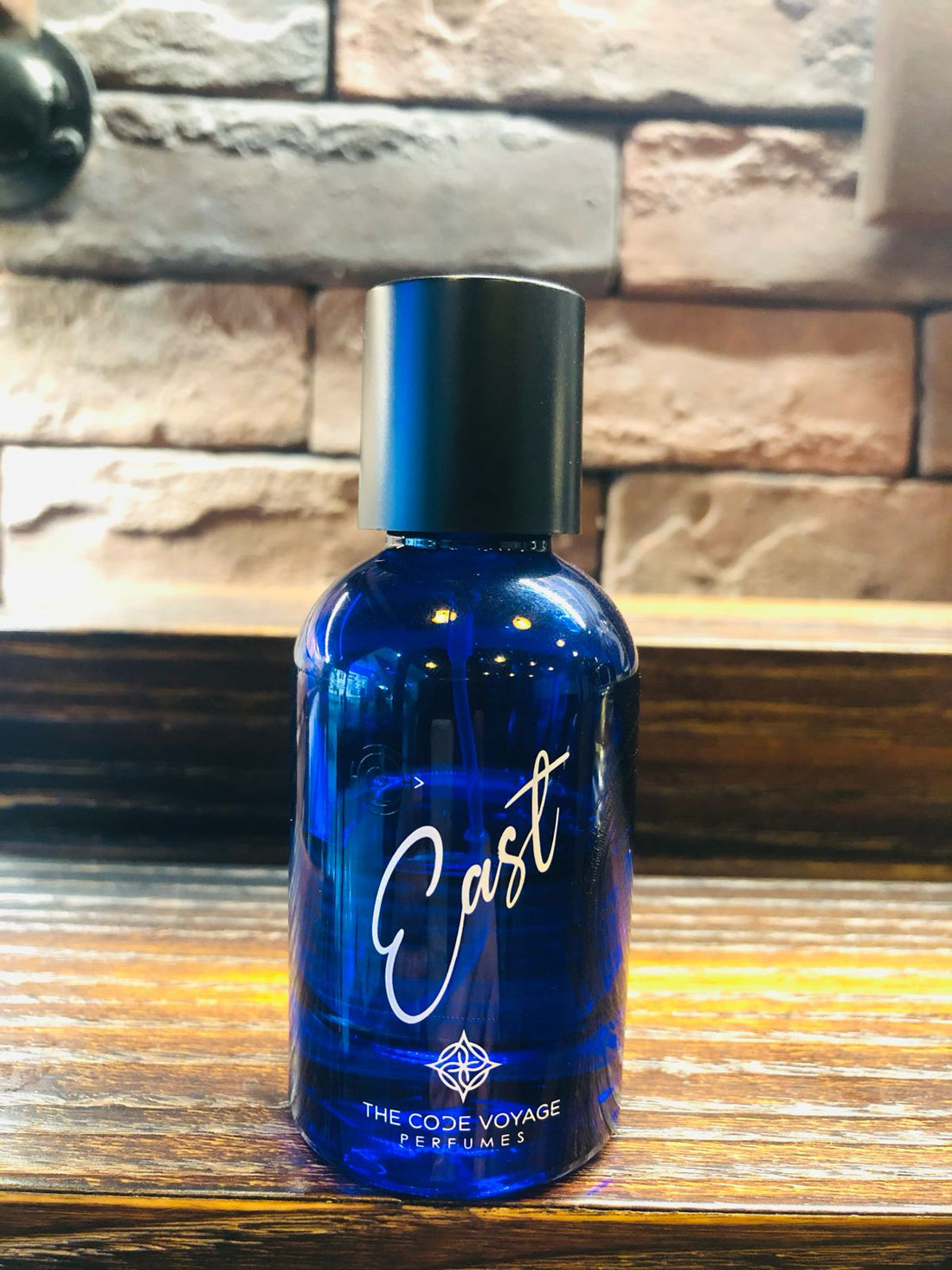 EAST perfume Dubai by THE CODE VOYAGE in a blue glass bottle with a sleek design