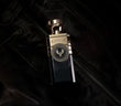 Electimuss Vici Leather perfume bottle with gold and black design placed on black leather jacket