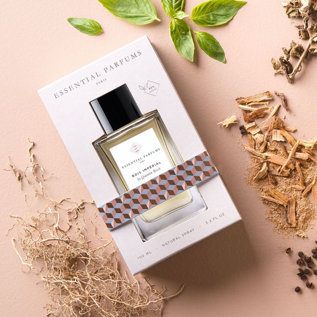 Essential Parfums Bois Imperial Eau de Parfum bottle in white box surrounded by natural wood and herb elements