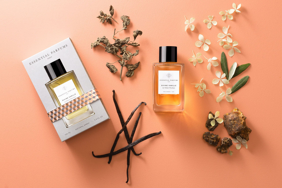 Essential Parfums Divine Vanille eau de parfum bottle with packaging and vanilla ingredients on peach background