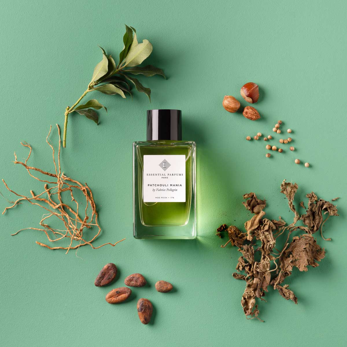 Essential Parfums Patchouli Mania perfume bottle with natural ingredients on green background