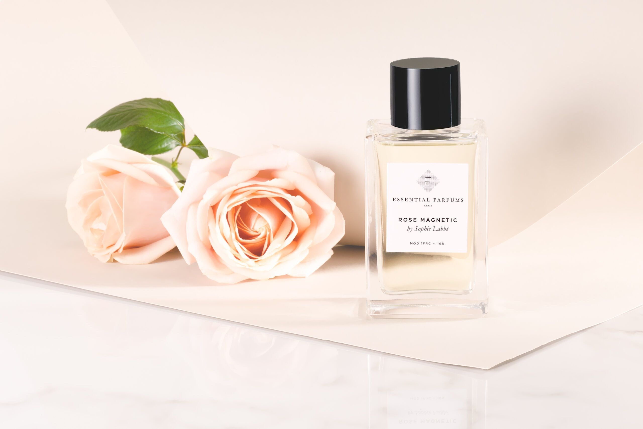 Essential Parfums Rose Magnetic perfume bottle with two pale pink roses on a light background