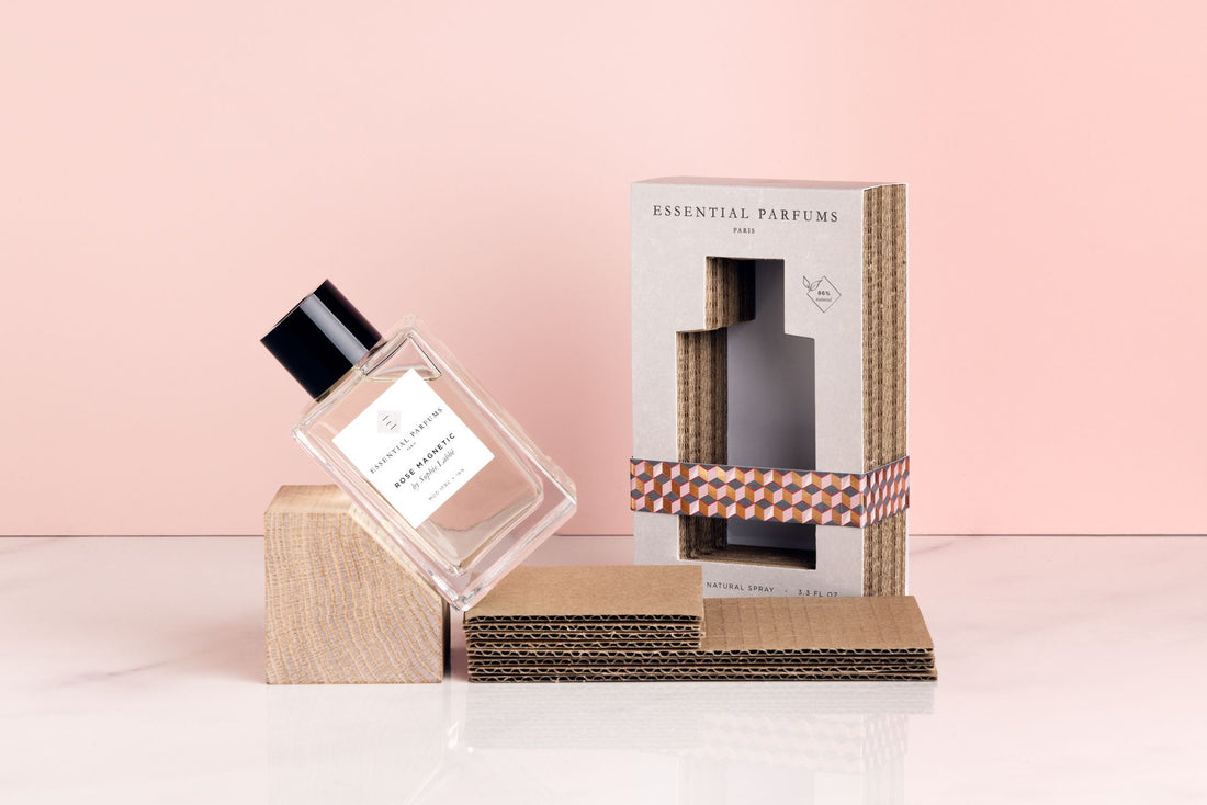 Essential Parfums Rose Magnetic perfume bottle and box with floral and natural elements on pink background