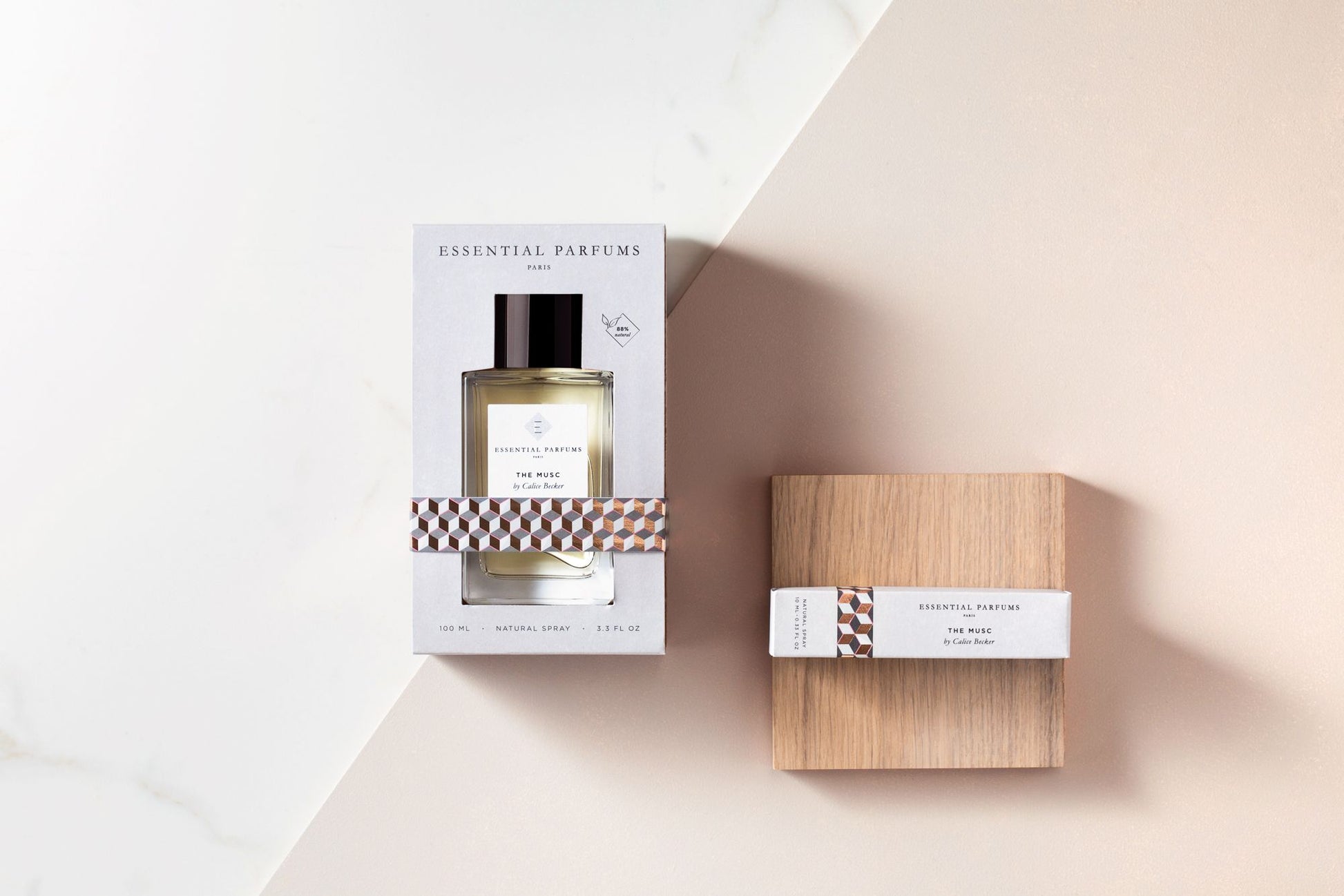 Essential Parfums The Musc 100ml perfume bottle in box with wooden cap packaging on beige and white background