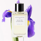 Essential Parfums Velvet Iris EDP perfume bottle with purple iris flower background