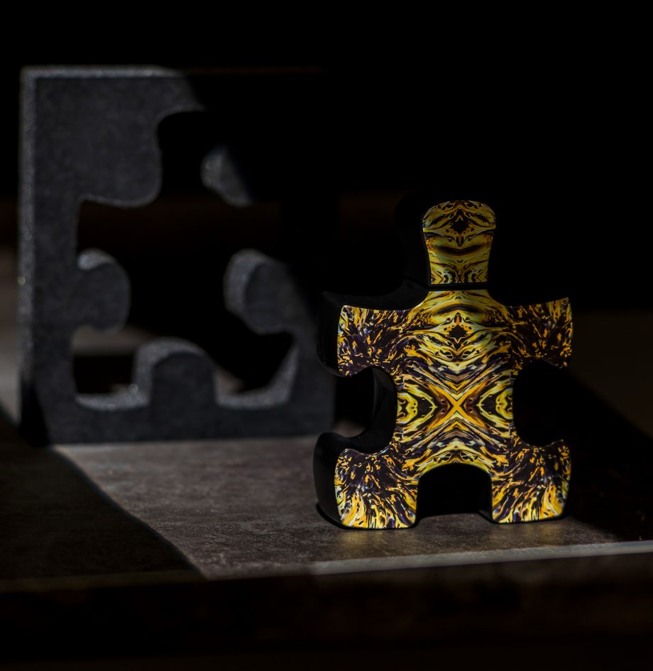 Puzzle Perfume bottle shaped like a yellow and black jigsaw piece representing Fibonacci perfume Dubai